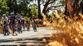 Ally Wollaston shines at the Santos Tour Down Under Women's Race, facing challenges ahead with determination and team support.