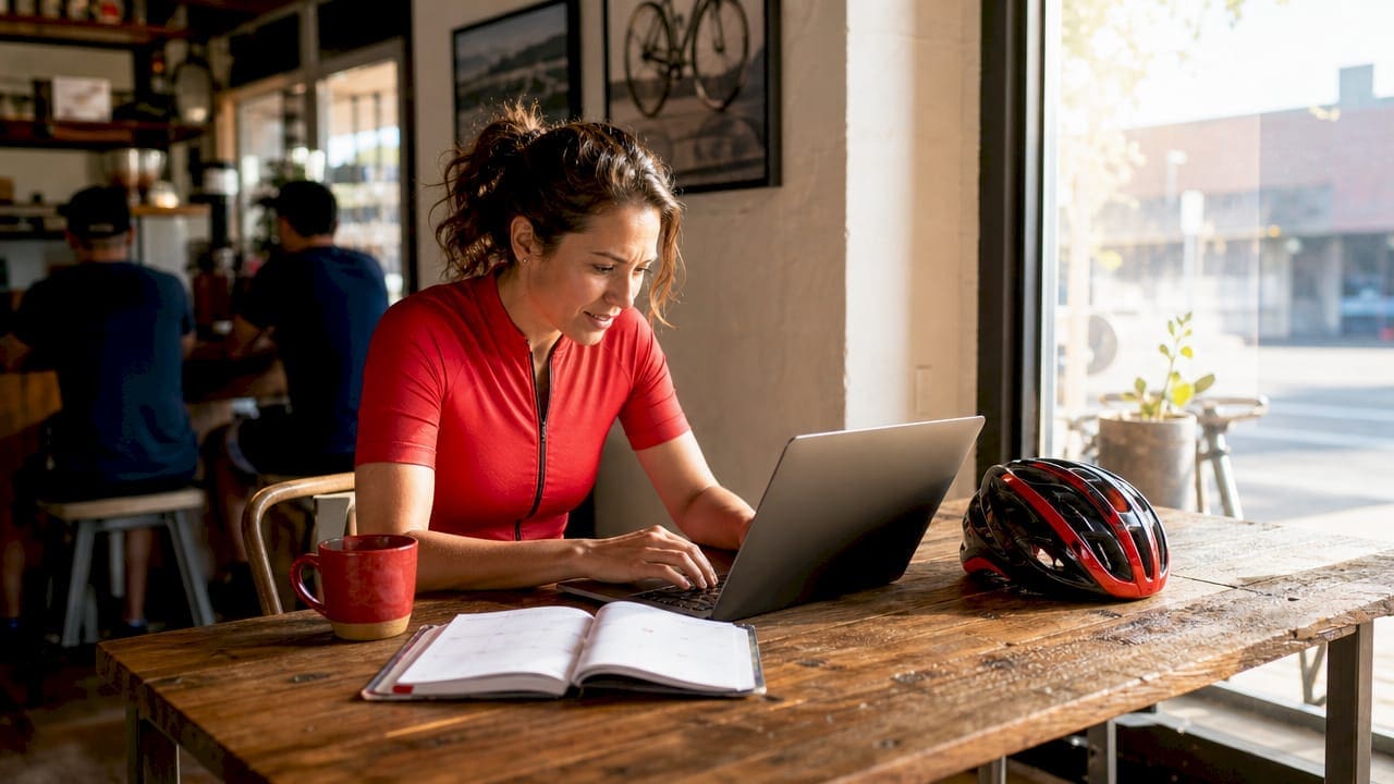 Person browsing gravel race listings on laptop