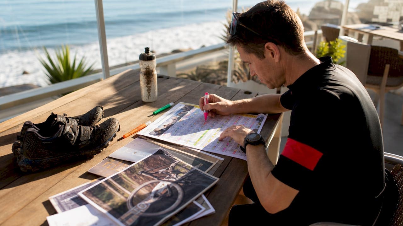 Cyclist planning cyclocross race schedule at home