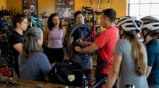 Outdoor community bike shop event with diverse cyclists