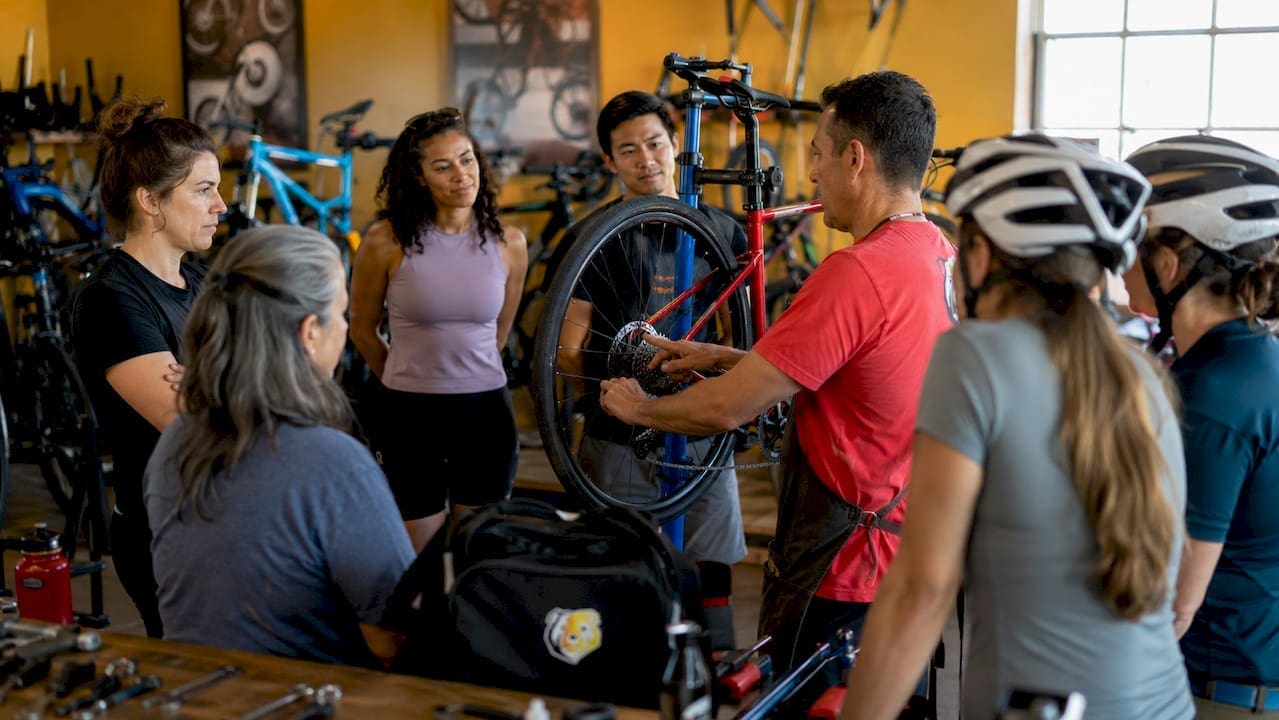 Outdoor community bike shop event with diverse cyclists