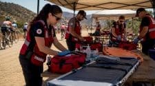Cycling event medical staff preparing equipment outdoors