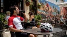 Cyclist resting outside bike shop after ride